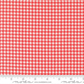 a red and white patterned fabric with a repeating geometric design.
