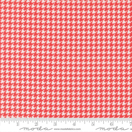 a red and white patterned fabric with a repeating geometric design.