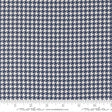 a close-up view of a fabric with a repeating pattern of white and navy blue houndstooth shapes.