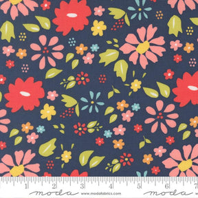 The image is a fabric with a floral pattern in shades of blue, pink, and yellow. The pattern consists of various flowers and leaves in different sizes and colors, creating a vibrant and lively design.
