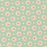 a repeating pattern of circular floral designs on a light green background, with white polka dots scattered throughout.