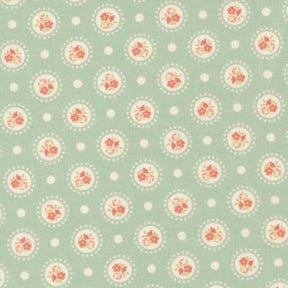 a repeating pattern of circular floral designs on a light green background, with white polka dots scattered throughout.
