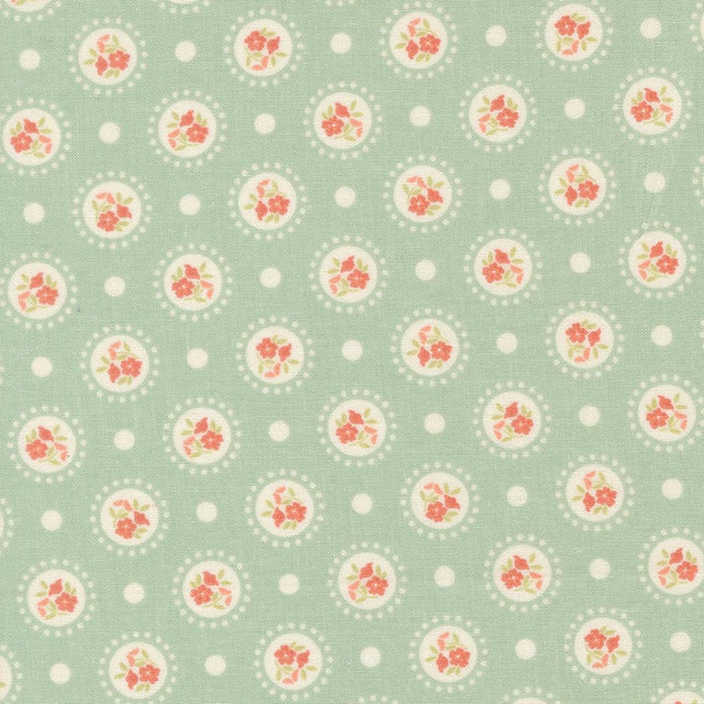 a repeating pattern of circular floral designs on a light green background, with white polka dots scattered throughout.