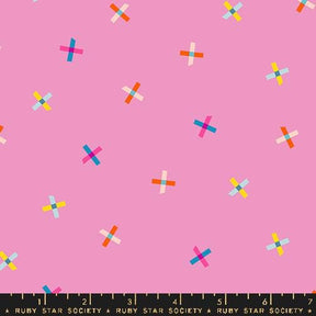 a pattern of colorful crosses on a pink background.
