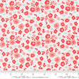The image is a fabric with a floral pattern in shades of red and white. The pattern consists of various red flowers and leaves scattered across the fabric, creating a visually appealing and vibrant design.