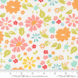The image is a fabric with a floral pattern, featuring various colorful flowers and leaves in shades of orange, pink, yellow, and green.