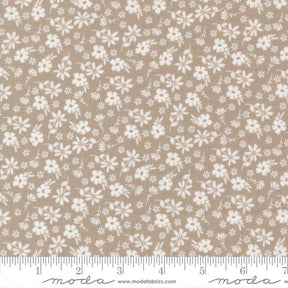 a fabric with a repeating pattern of white flowers on a beige background. The pattern is spread across the entire fabric, creating a visually appealing and intricate design.