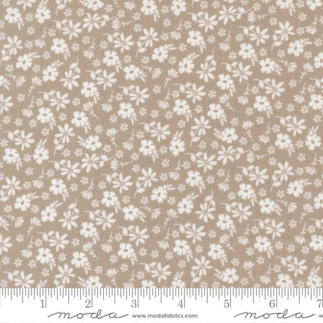 a fabric with a repeating pattern of white flowers on a beige background. The pattern is spread across the entire fabric, creating a visually appealing and intricate design.