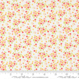 The image is a fabric with a floral pattern, featuring small red, yellow, and green flowers scattered across a white background.