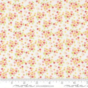 The image is a fabric with a floral pattern, featuring small red, yellow, and green flowers scattered across a white background.