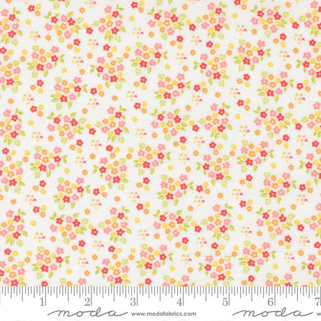 The image is a fabric with a floral pattern, featuring small red, yellow, and green flowers scattered across a white background.