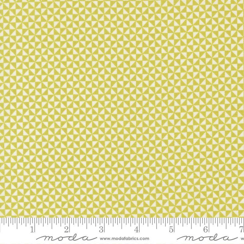 a repeating pattern of yellow triangles on a fabric surface.