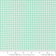 a fabric with a repeating pattern of green and white houndstooth shapes, creating a houndstooth pattern.