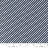 a close-up view of a fabric with diagonal white stripes arranged in a diagonal pattern. The fabric appears to be navy blue in color.