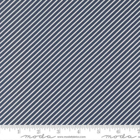 a close-up view of a fabric with diagonal white stripes arranged in a diagonal pattern. The fabric appears to be navy blue in color.