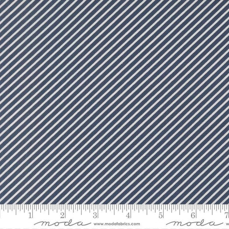 a close-up view of a fabric with diagonal white stripes arranged in a diagonal pattern. The fabric appears to be navy blue in color.