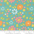 The image is a fabric with a floral pattern in shades of green, orange, and pink. The pattern consists of various flowers and leaves in different sizes and orientations, creating a vibrant and lively design.