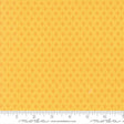 The image is a close-up of a fabric with a repeating pattern of small orange dots or circles, creating a textured and visually interesting surface.
