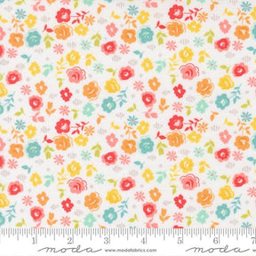 The image is a fabric with a floral pattern, featuring various colorful flowers and leaves in different shades of orange, yellow, green, and pink. The fabric appears to be a soft, pastel-colored material, suitable for sewing or other textile applications.