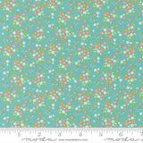 a fabric with a floral pattern in shades of green and pink. The pattern consists of small flowers and leaves scattered across the fabric, creating a vibrant and colorful design.