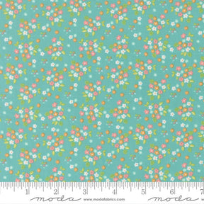 a fabric with a floral pattern in shades of green and pink. The pattern consists of small flowers and leaves scattered across the fabric, creating a vibrant and colorful design.