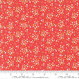 The image is a vibrant red fabric with a repeating pattern of small white and pink flowers and leaves. The fabric appears to be a fabric with a floral print, and it is displayed on a ruler for size reference.