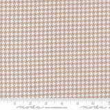 a repeating pattern of brown and white houndstooth designs, creating a visually appealing and intricate pattern.