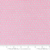 a close-up view of a fabric with a pink floral pattern. The fabric appears to be made of Moda cotton material, as indicated by the text in the image.