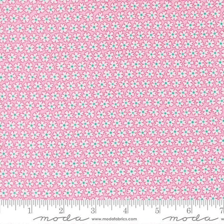 a close-up view of a fabric with a pink floral pattern. The fabric appears to be made of Moda cotton material, as indicated by the text in the image.