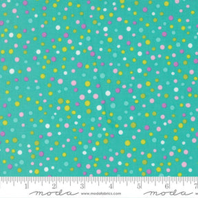 The image is a close-up of a fabric with a pattern of multicolored dots in various shades of green, yellow, and pink. The dots are scattered randomly across the fabric, creating a vibrant and lively visual effect.
