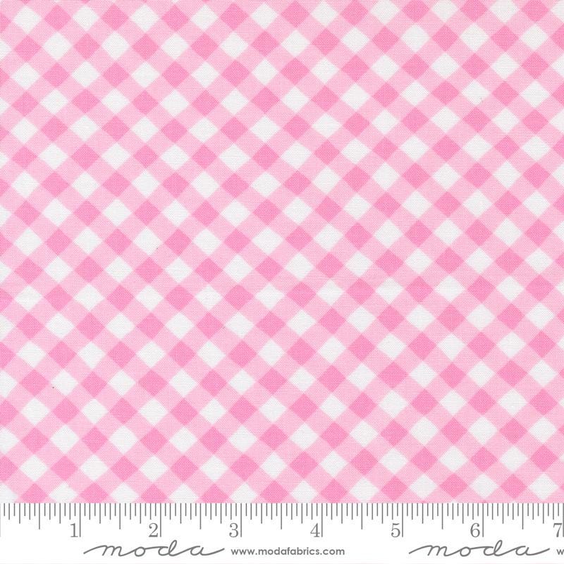 a close-up view of a fabric with a pink and white gingham pattern. The fabric appears to be a soft, textured material with a diagonal grid-like pattern. The image does not contain any text or other objects, and the focus is solely on the fabric's texture and pattern.