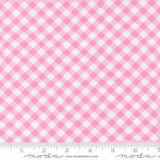 a close-up view of a fabric with a pink and white gingham pattern. The fabric appears to be a soft, textured material with a diagonal grid-like pattern. The image does not contain any text or other objects, and the focus is solely on the fabric's texture and pattern.