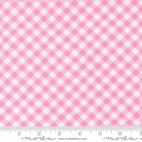 a close-up view of a fabric with a pink and white gingham pattern. The fabric appears to be a soft, textured material with a diagonal grid-like pattern. The image does not contain any text or other objects, and the focus is solely on the fabric's texture and pattern.