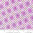 a repeating pattern of purple and white circles on a fabric surface.