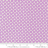 a repeating pattern of purple and white circles on a fabric surface.