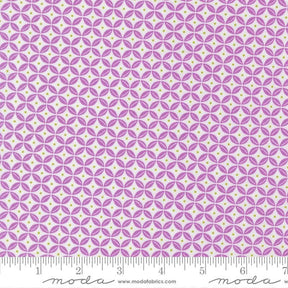 a repeating pattern of purple and white circles on a fabric surface.