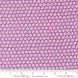 a fabric with a repeating pattern of white flowers on a purple background. The fabric appears to be a fabric with a floral pattern, and the image is described as a fabric with a floral pattern.