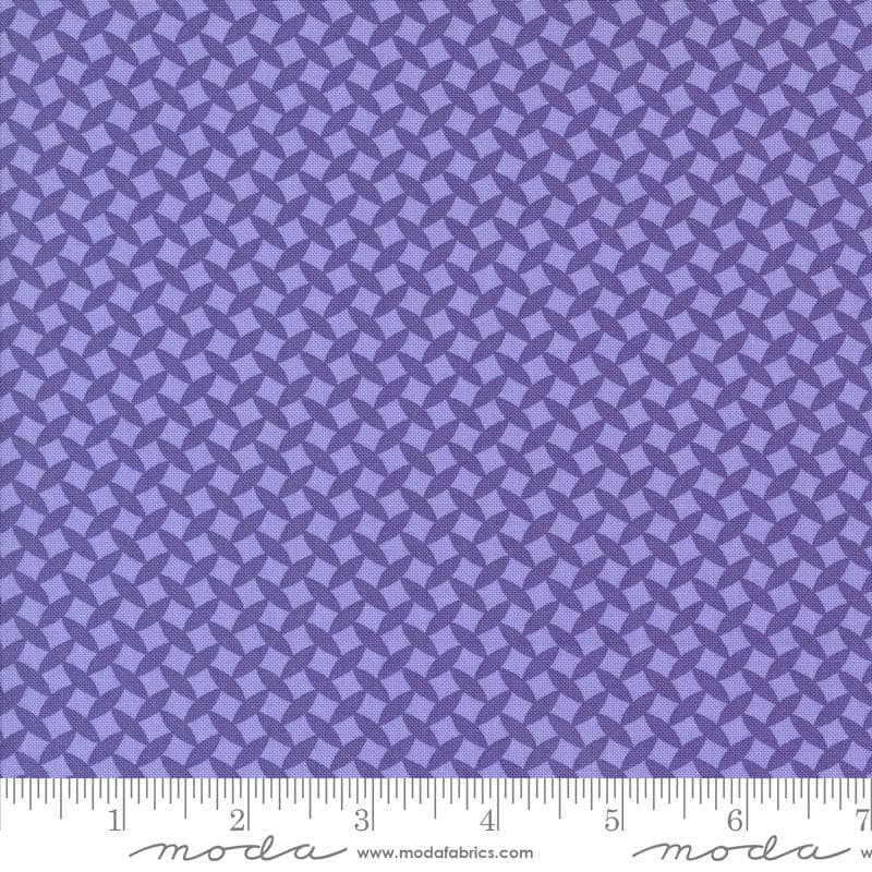 a close-up view of a fabric with a repeating pattern of purple diamonds or squares, creating a visually striking and intricate design.