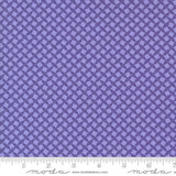 a close-up view of a fabric with a repeating pattern of purple diamonds or squares, creating a visually striking and intricate design.