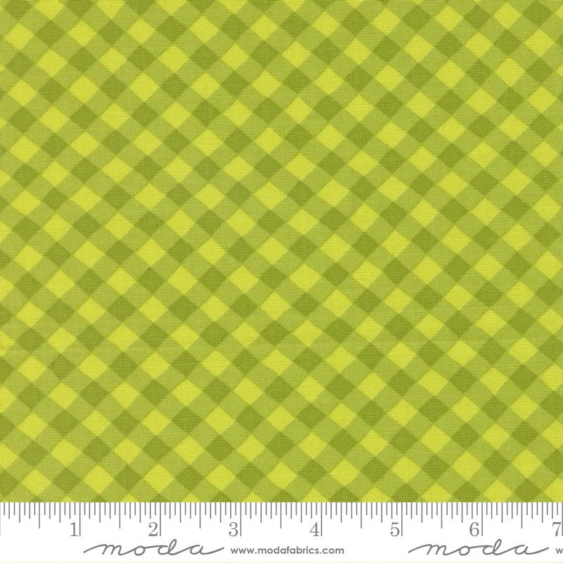 a close-up view of a fabric with a diagonal green and yellow checkered pattern.
