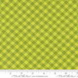 a close-up view of a fabric with a diagonal green and yellow checkered pattern.