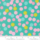 The image is a fabric with a pattern of multicolored polka dots in various shades of pink, yellow, and green. The pattern is scattered across the fabric, creating a vibrant and playful design.