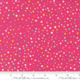The image is a close-up of a fabric with a vibrant pink background adorned with multicolored polka dots in various sizes and shades.