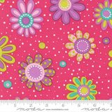 The image is a vibrant and colorful fabric with a repeating pattern of large, stylized flowers in shades of pink, purple, and yellow, along with polka dots and dots. The fabric appears to be a soft pink color, and the pattern is spread across the entire surface, creating a visually striking and lively design.