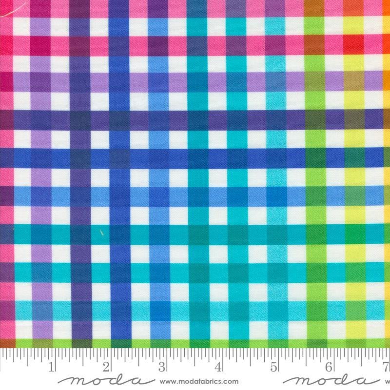 The image is a close-up of a fabric with a checkered pattern in various colors, including pink, blue, green, and yellow. The fabric appears to be a multicolored plaid pattern, with the colors and patterns repeating across the fabric.