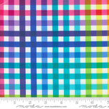 The image is a close-up of a fabric with a checkered pattern in various colors, including pink, blue, green, and yellow. The fabric appears to be a multicolored plaid pattern, with the colors and patterns repeating across the fabric.