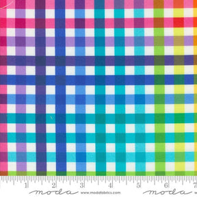 The image is a close-up of a fabric with a checkered pattern in various colors, including pink, blue, green, and yellow. The fabric appears to be a multicolored plaid pattern, with the colors and patterns repeating across the fabric.