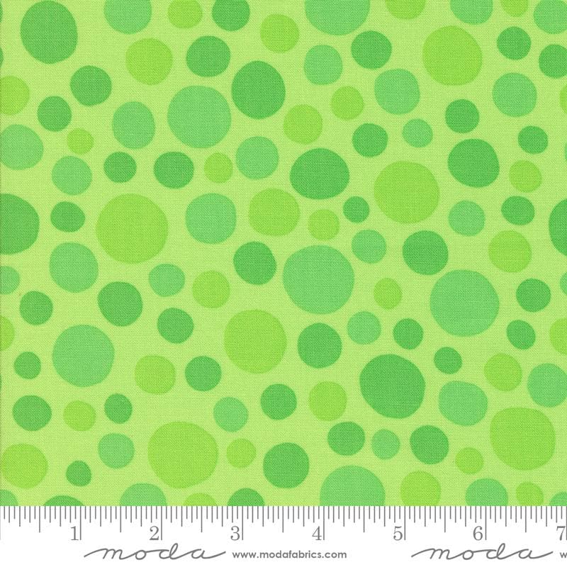 The image is a fabric with a green polka dot pattern.