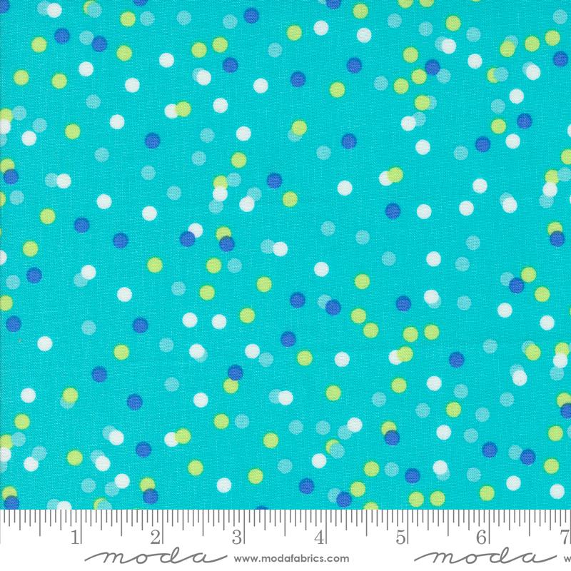 The image is a close-up of a fabric with a pattern of multicolored dots on a turquoise background.