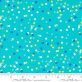 The image is a close-up of a fabric with a pattern of multicolored dots on a turquoise background.